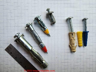 Examples of molly bolts and push-in ribbed plastic wall hanger anchors (C) Daniel Friedman at InspectApedia.com