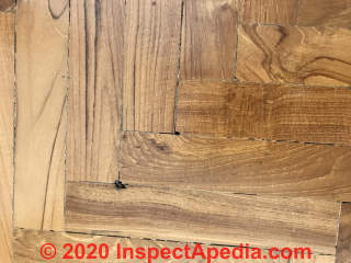 Damaged wood parquet flooring diagnosis (C) InspectApedia.com sharon