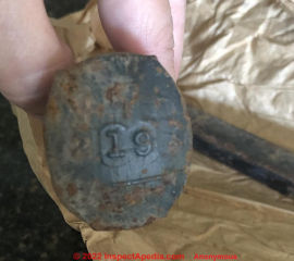 Numbers embossed into the head of a Shawnee Oklahoma railroad spike head (C) InspectApedia.com Anonymous