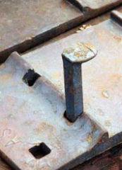 Railroad spike and tie plate cited & discussed at InspectApedia.com