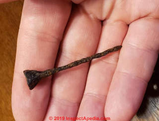 Horse shoe nail at InspectApedia.com - old, rusty, age is a guess