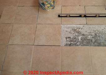 Test fit replacement ceramic tiles before starting to glue them down with tile mastic (C) Daniel Friedman at InspectApedia.com