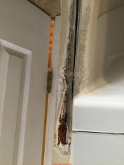 Rusty corner molding at a bath tub or shower enclosure (C) InspectApedia.com Nicole