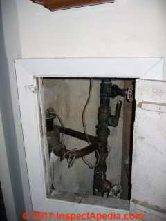 Mold on plumbing access cover interior surface (C) InspectApedia.com