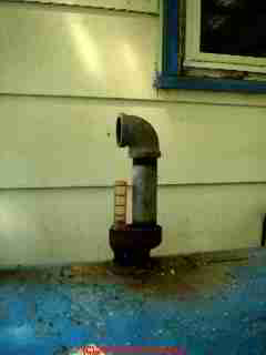 Photograph of  an indoor oil tank used outside and exposed to roof spillage and water entry at the oil tank vent pipe (shown in photo) Photo  © 2010 Arlene Puentes