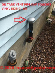 Is it OK for the oil tank vent pipe cap to touch my vinyl siding? (C) InspectApedia.com Sidoli