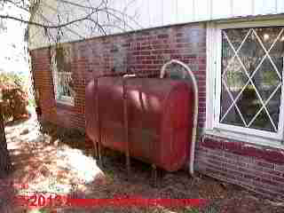 Photograph of rusty oil tank supporting leg, indicating a history of basement water entry