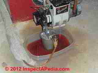 Oil filter change at heating boiler or furnace © D Friedman at InspectApedia.com 