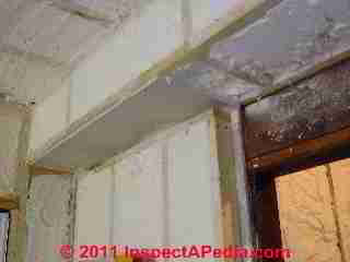 Friedman Galow 5Mc Addition foam insulation in pipe chase prevents noise transmission from ABS drain line routed overhead (C) Daniel Friedman at InspectApedia.com