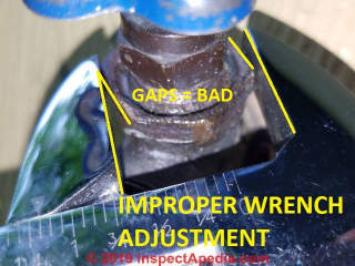 Improperly adjusted wrench damages the nut and skins your knuckles (C) Daniel Friedman at InspectApedia.com