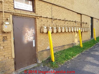 I-beams set as vertical posts to serve as "bollards" to protect some of the gas meters along a parking lot in Two Harbors Minnesota (C) Daniel Friedman at InspectApedia.com