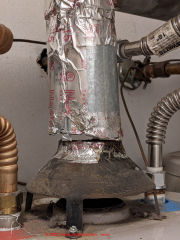 Gas fueled water heater not connected to flue, leaky, risking CO Carbon Monixde hazards (C) InspectApedia.com Nesbitt