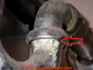 Leak at the coupling nut on a chrome plated brass plumbing trap slip joint connector (C) Daniel Friedman InspectApedia.com
