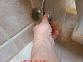 Step in removing an old toilet - turn off the water supply and remove water from the toilet tank & bowl (C) Daniel Friedman at InspectApedia.com
