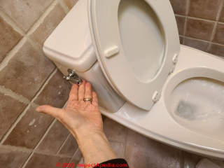 Step in removing an old toilet - turn off the water supply and remove water from the toilet tank & bowl (C) Daniel Friedman at InspectApedia.com