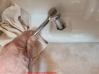 Use a deep socket for easy removal of toilet mounting bolts (C) Daniel Friedman at InspectApedia.com