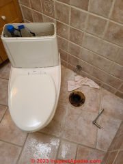 Old toilet now removed from its mount atop the drain waste pipe (C) Daniel Friedman at InspectApedia.com