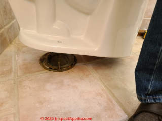 Carefully lower the new toilet and its wax seal into place (C) Daniel Friedman at InspectApedia.com
