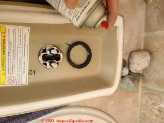 Install the dual flush valve into the toilet tank top  (C) Daniel Friedman at InspectApedia.com