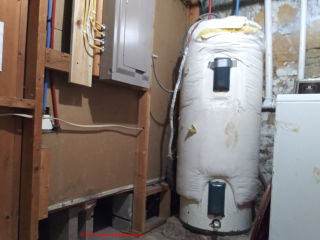 Unsafe Rheem electric water heater (C) InspectApedia.com Hogue 