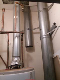 Unsafe gas water heater, not venting, uses an alulminum foil draft hood (C) Inspectapedia.com Amanda
