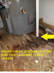 Unsafe water heater relief valve in Watertown New York apartments - tube discharge outlet against floor (C) Inspectapedia.com Puentes