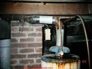 Gas water heater vented into masonry flue - severe water damage (C) Daniel Friedman at InspectApedia.com