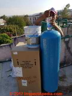 Placing gravel then resin into the water softener resin tank (C) Daniel Friedman