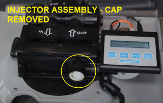 Water softener injector located beneath screw cap on front of control head (C) InspectApedia.com
