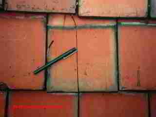 Broken roof tile © D Friedman at InspectApedia.com 