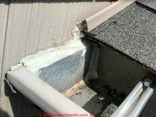Flashing omitted at roof-wall and over gutter end cap cause leaks (C) Inspectapedia.com Ed