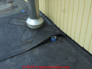 Prop open leaky rubber roof seam to allow drying before starting repair (C) Daniel Friedman at InspectApedia.com
