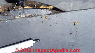 Rubber roof sealant applied over a leay EPDM roof seam (C) Daniel Friedman at InspectApedia.com