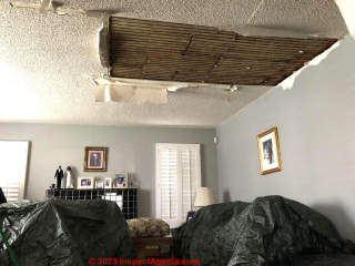 roof and ceiling damage after rain entry from unprotected roof (C) InspectApedia.com Julie