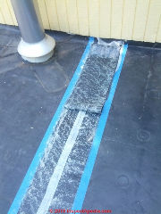 EPDM roof repair with a strip of EPDM roofing and spray-on adhesive (C) Daniel Friedman at InspectApedia.com