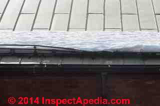 Bent failing snow fence on a metal roof (C) Daniel Friedman