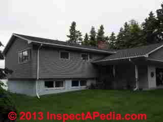 Gable roof constructed atop original flat roofed building (C) InspectApedia