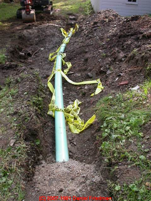 Photograph of a new plastic sewer line being installed.