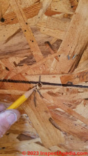 Check exact pilot bit location before beginning to cut larger round hole in wall for Cinderella toilet exhaust vent pipe  - (C) Daniel Friedman at InspectApedia.com