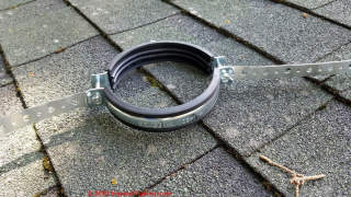 Factory clamp for incinerating toilet chimney vent with added-on plumbing strapping for angle braces  - (C) Daniel Friedman at InspectApedia.com