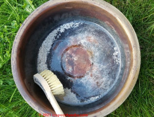 Soft bristle brush cleaning the Cinderella incinerating toielt ash pan (C) InspectApedia.com