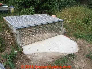 Access cover for concrete septic tank converted to underground storage room (C) InspectApedia.com KH