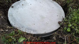 Round septic tank cover on riser - is the riser sealed to the tank? Is the cover safe? (C) Inspectapedia.com MC
