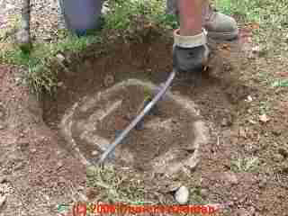 PHOTO of the septic tank cleanout cover having been exposed by excavation