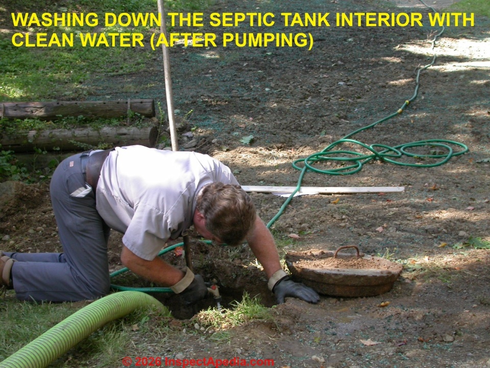 Leaning into a septic tank opening, in this case to wash down the tank with clean water, can be dangerous (C) Daniel Friedman at InspectApedia.com.