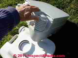 Accordian valve flusher on porta potty © D Friedman at InspectApedia.com 