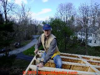 D Friedman nailing strapping to tie roof I-trusses to the building wall and beam © Daniel Friedman at InspectApedia.com