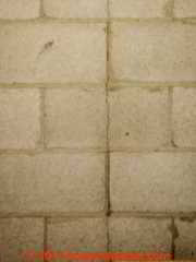 Vertically cracked concrete block or cinderblock foundation wall © Daniel Friedman at InspectApedia.com