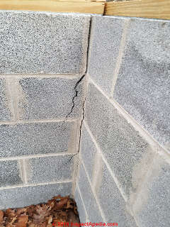 Vertical crack in concrete block wall, new construction, freezing (C) InspectApedia.com CB