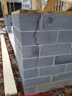 Vertical crack in concrete block wall, new construction, freezing (C) InspectApedia.com CB